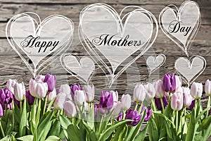 Happy mother`s day text heart with pink and white tulips rustic wooden background greeting card spring flowers