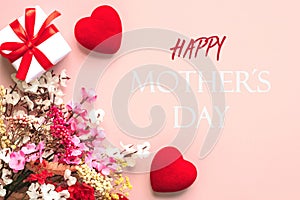 Happy Mother\'s Day. Top view of flowers,gift box and red hearts with the text Happy Mothers day