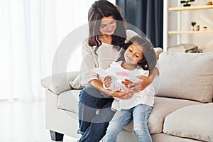 Happy mother`s day. Woman and her daughter spending time together at home