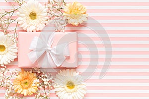 Happy Mother`s Day, Women`s Day, Valentine`s Day or Birthday Pastel Pink Background. Floral greeting card with beautiful present.