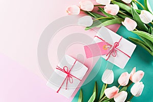 Happy Mother`s Day, Women`s Day or Valentine`s Day greeting concept. Pastel Colours Background with  tulip flowers and gift box