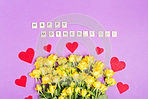 Happy mother`s day with yellow roes flowers on purple table background top view with free space copy space romantic