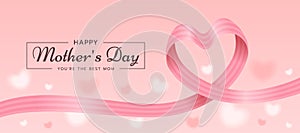 Happy mother`s day, you are the best mom text and soft pink ribbon roll wave make heart shape on hearts blur texture background