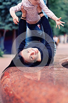 Happy mother and small daugher in a park