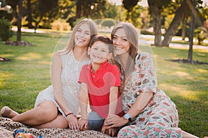 Happy mother, son and daughter in the park.Family having fun outdoors. Happy family concept