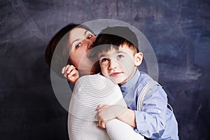 Happy mother and son having fun, laughing and hugging. Beautiful woman and her cute little child boy playing and smiling