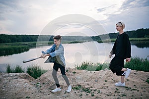 happy mother and son playing with baseball bat