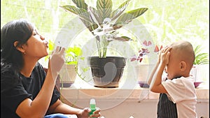 Happy mother and son playing bubble,