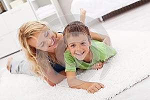 Happy mother and son playing in the living room