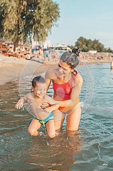 Happy mother and son playing in the water