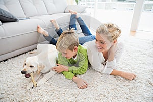 Happy mother and son with puppy