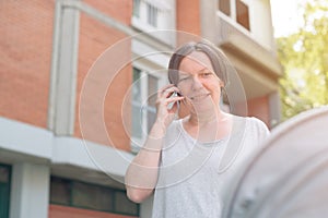 Happy mother talking on mobile phone