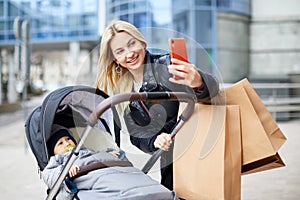 Happy Mother Talking on the Phone and Walking her Baby