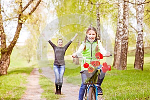 Happy mother teaches his daughter to ride a bike. A mother is glad to successes of daughter