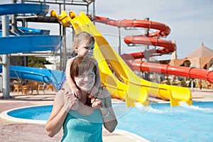 Happy mother with toddler at aquapark