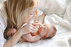 Happy Mother Touching Newborn Baby Daughters Nose
