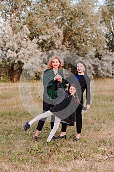 Happy mother and two daughters in the summer on walk