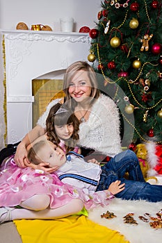 Happy mother and two her children in Christmas