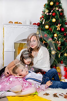 Happy mother and two her children in Christmas