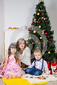 Happy mother and two her children in Christmas