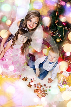 Happy mother and two her children in Christmas