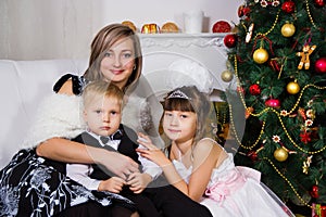 Happy mother and two her children in Christmas