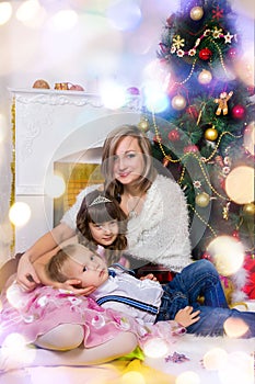 Happy mother and two her children in Christmas