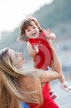 Happy mother with a young daughter near Yacht Club