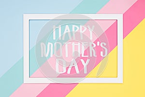 Happy Mothers Day abstract geometrical pastel blue, pink and yellow paper flat lay background. Minimalism greeting card. photo