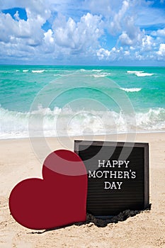 Happy Mothers day beach background with black board and heart