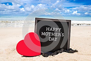 Happy Mothers day beach background with black board and heart