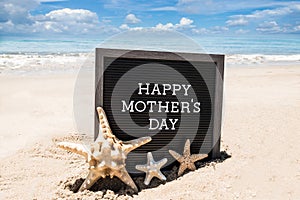 Happy Mothers day beach background with black board and starfishes