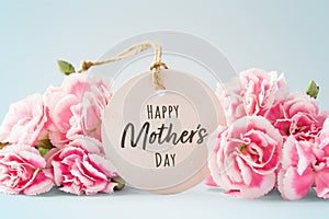 Happy mothers day card with pink flowers on blue background