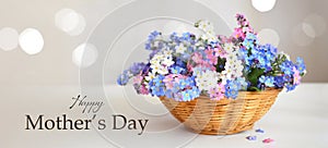 Happy Mothers Day card. Spring flowers in woven basket