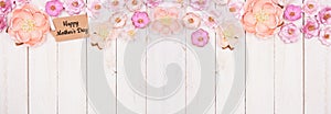 Happy Mothers Day gift tag with top border of pink paper flowers over a white wood banner background