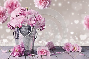 Happy mothers day letter on wood heart and pink carnation flower