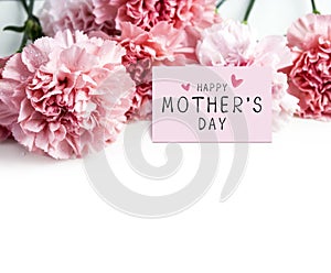 Happy mothers day message on paper and pink carnation flower