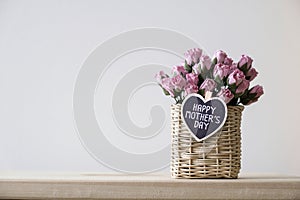 Happy mothers day message on wood heart and pink paper roses