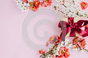 Happy Mothers day. Stylish gift box with flowers on pink background flat lay. Greeting card template with space for text. Craft