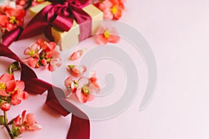 Happy Mothers day. Stylish gift box with red flowers close up on pink background. Greeting card template with space for text.