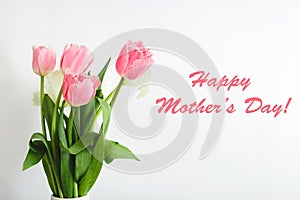 Happy Mothers Day text on gift card in flower bouquet on white background. Greeting card for Mom. Flower delivery, Congratulations