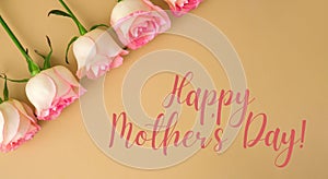 HAPPY MOTHERS DAY text greeting card Delicate pink roses on beige background. Minimal trendy composition. Romantic