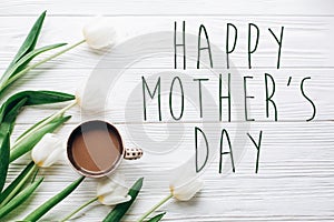 Happy mothers day text sign on tulips and coffee on white wooden