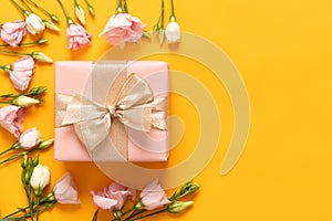 Happy Mothers Day, Womens Day, Valentines Day or Birthday Yellow and Pastel Pink Colored Background. Flat lay with gift box.
