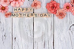 Happy Mothers Day wooden blocks with flower top border on white wood photo