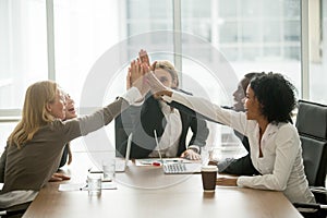 Happy motivated multiracial business team giving high five at me