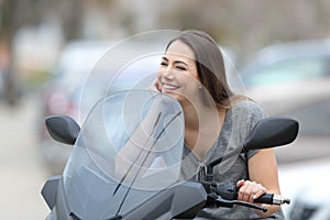 Happy motorbiker on a motorbike looking away