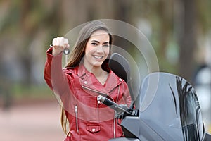 Motorcycle buyer showing keys at camera photo