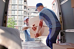 Happy movers loading truck with items