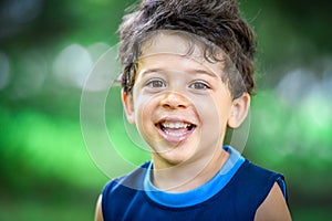 Happy mulatto boy child is smiling enjoying adopted life.